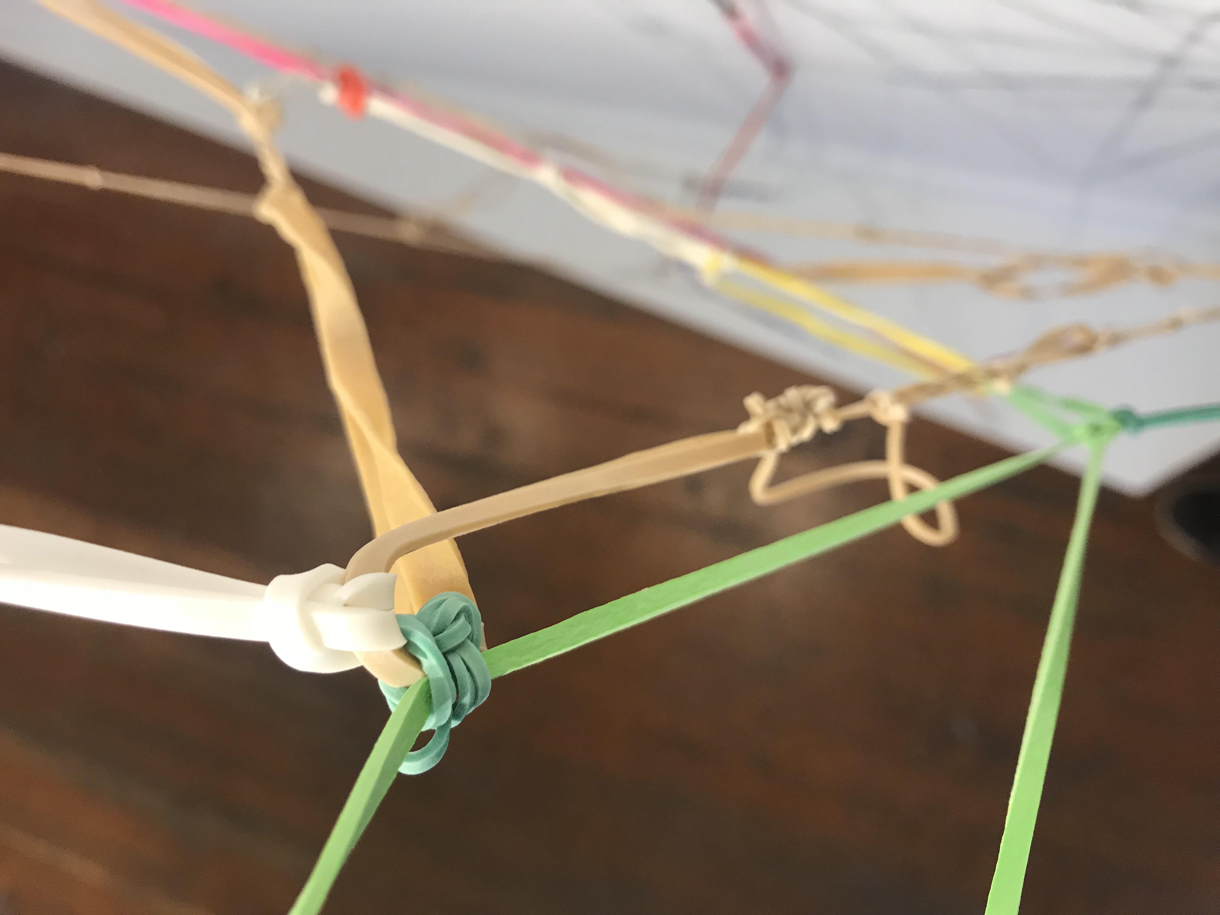 Close up image Eva Enriquez's installation of rubber bands tied together 