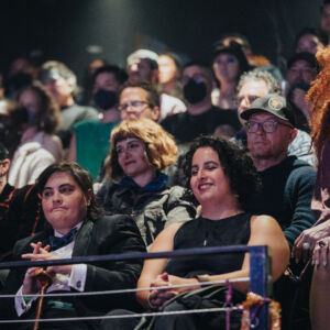 a colorful audience watches a show