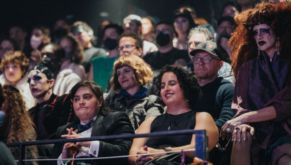 a colorful audience watches a show